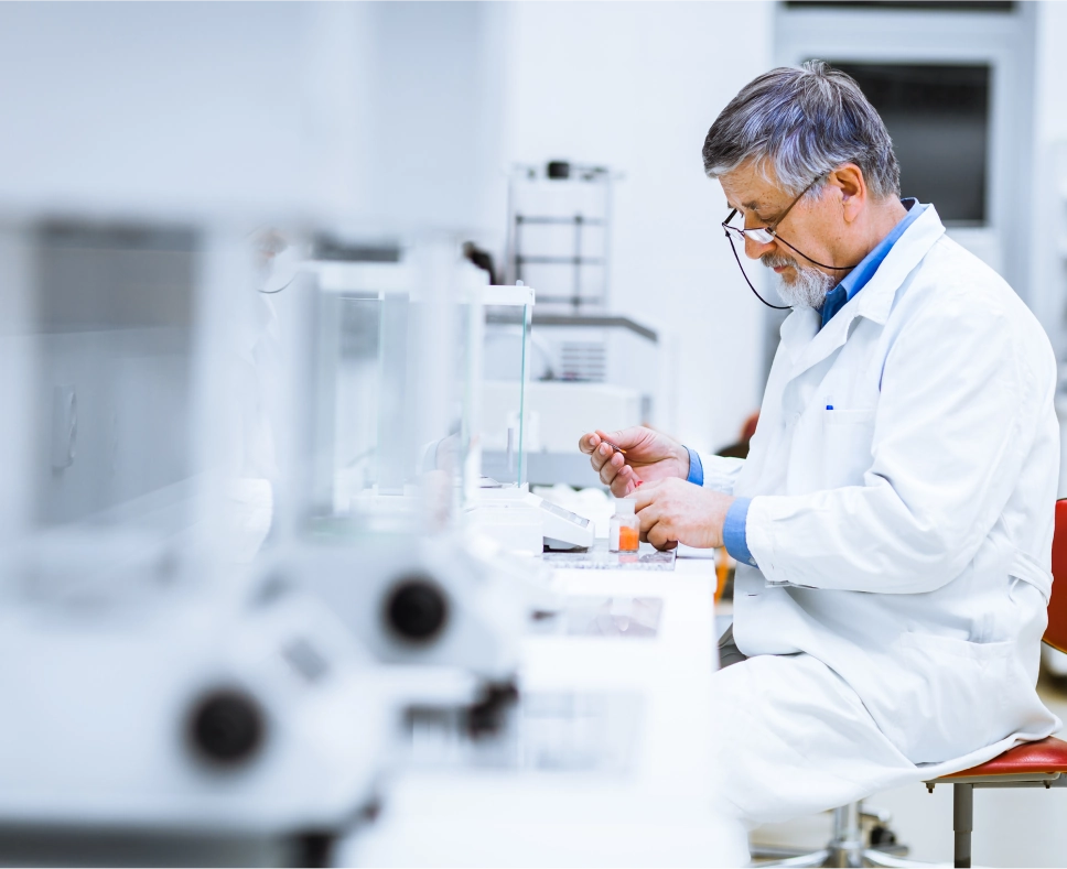 Industries 7 A scientist in a white lab coat tests a compound in a laboratory.